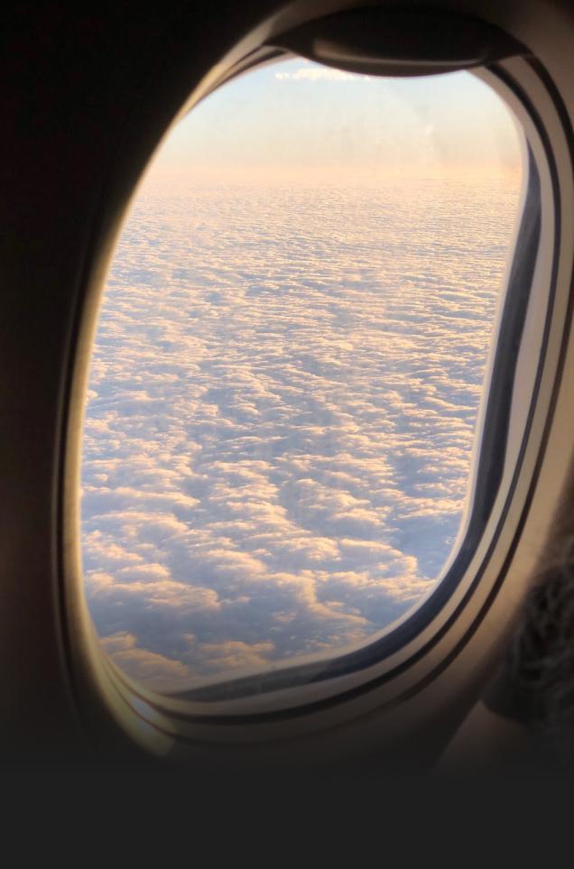 Airplane window above the clouds